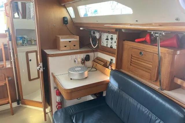 Slide: The Image of Interior of a 2000 Catalina 34 Mk II sailboat with wooden cabinetry and blue seating. - 13