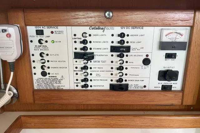 Slide: The Image of Control panel of a 2000 Catalina 34 Mk II yacht, featuring 120V AC and 12V DC services. - 16