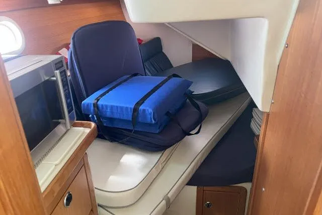 Slide: The Image of Interior of 2000 Catalina 34 Mk II sailboat with cushions and microwave. - 18