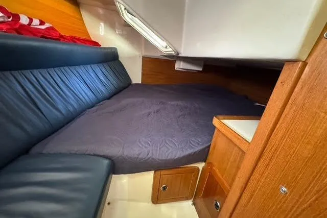 Slide: The Image of 2000 Catalina 34 Mk II cabin interior with cozy bed and wooden furnishings. - 19