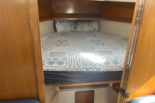 Slide: The Image of Cozy cabin interior of 2000 Catalina 34 Mk II sailboat with patterned bedding. - 21
