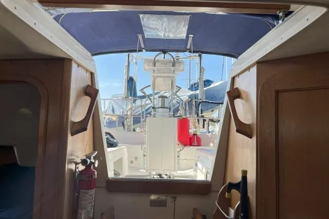 Slide: The Image of Interior view of a 2000 Catalina 34 Mk II sailboat cockpit with wooden accents. - 23
