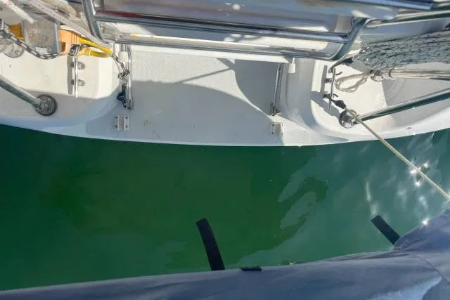 Slide: The Image of Catalina 34 Mk II sailboat deck, 2000 model, overlooking calm green water. - 33