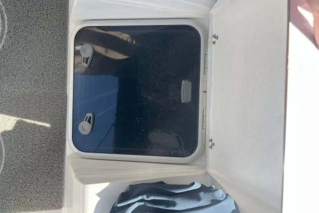 Slide: The Image of Hatch of a 2000 Catalina 34 Mk II sailboat, partially open with visible hinges. - 34