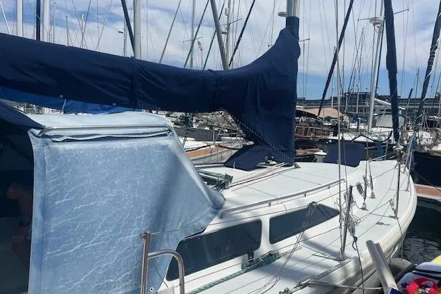 Slide: The Image of Catalina 34 Mk II sailboat, 2000 model, docked in a marina with blue covers. - 40