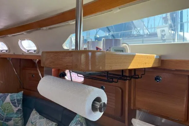 Slide: The Image of Interior of a 2000 Catalina 34 Mk II sailboat with paper towel holder and storage shelf. - 7