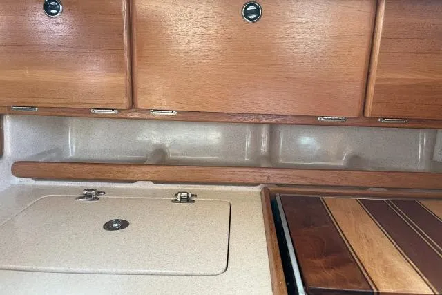 Slide: The Image of Interior of 2000 Catalina 34 Mk II sailboat with wooden cabinets and countertop. - 9