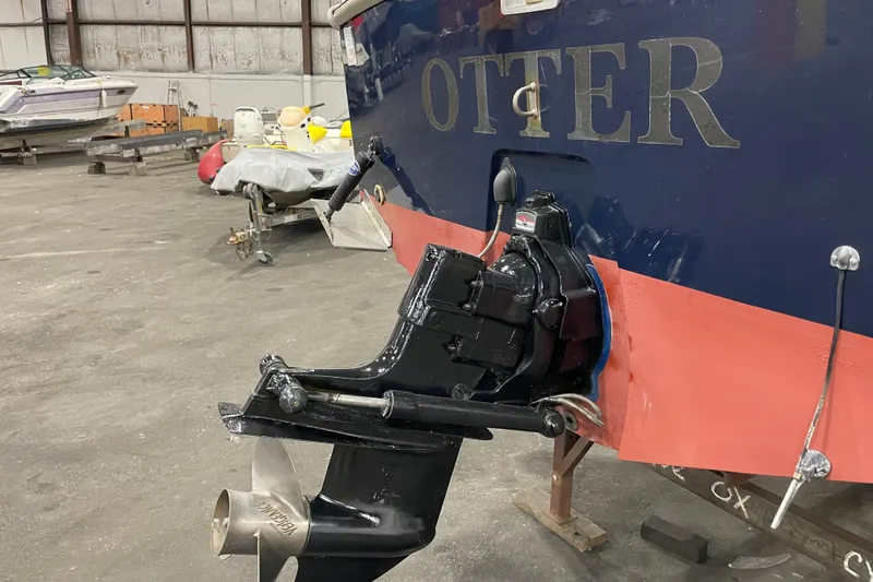 Slide: The Image of 1989 Limestone 24 boat in a warehouse, featuring a visible propeller and "OTTER" name. - 10