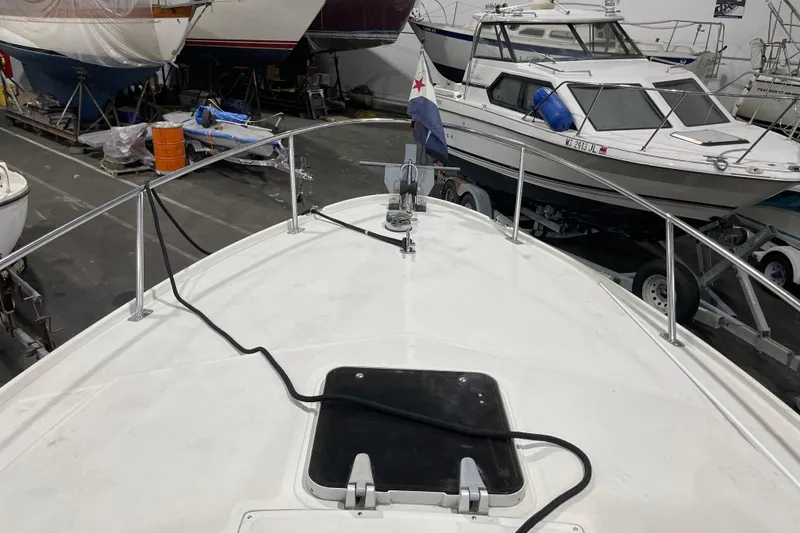 Slide: The Image of 1989 Limestone 24 boat in storage, surrounded by other vessels in a warehouse. - 14