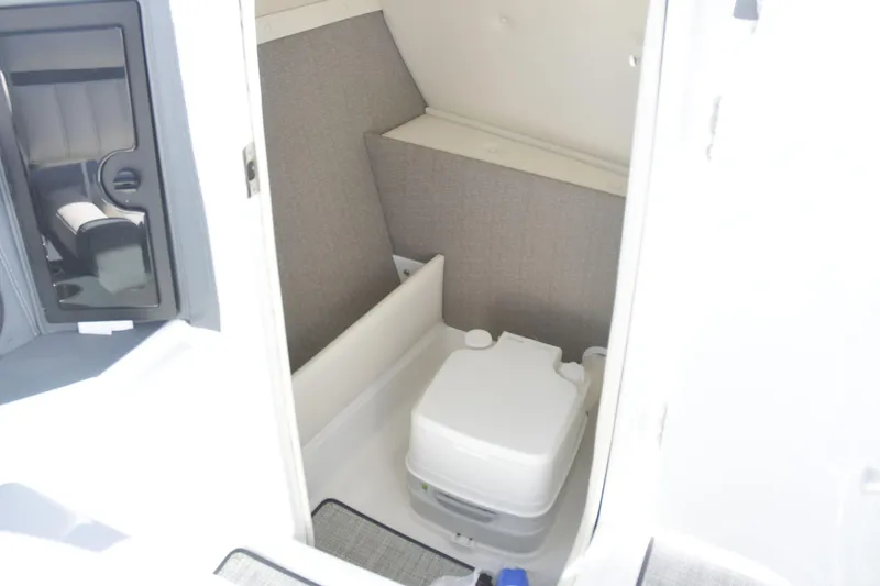 Slide: The Image of 2020 Cobalt 23SC boat interior with compact marine toilet. - 11