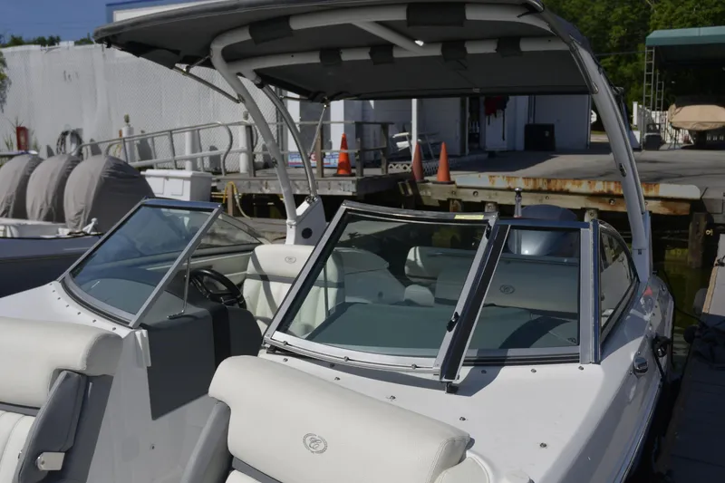 Slide: The Image of 2020 Cobalt 23SC boat docked, featuring sleek design and comfortable seating. - 13
