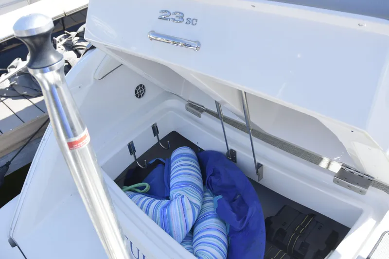 Slide: The Image of Open storage compartment of 2020 Cobalt 23SC boat with cushions inside. - 7