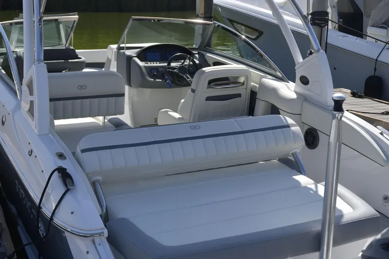 Slide: The Image of 2020 Cobalt 23SC boat interior with white seating and modern dashboard. - 9