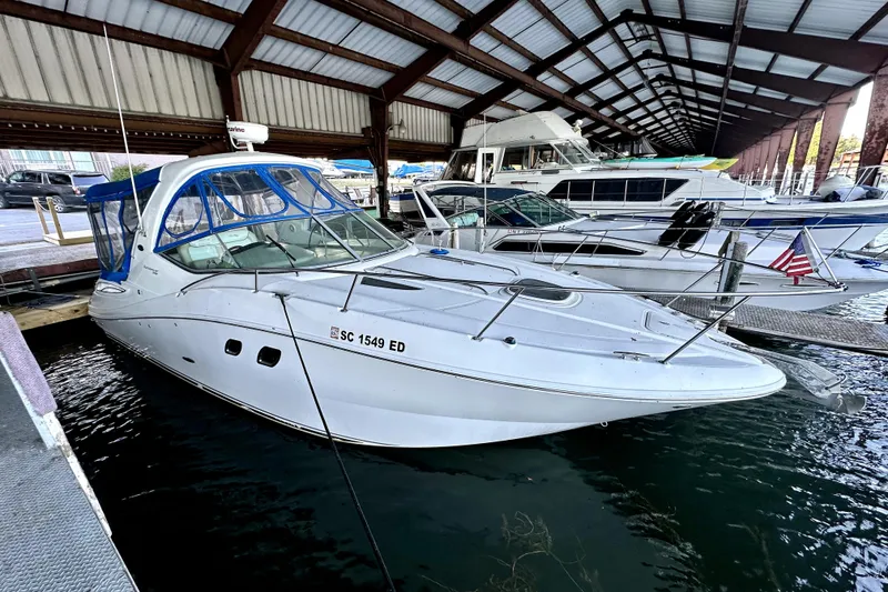 Slide: The Image of 2012 Sea Ray 330 Sundancer docked in a covered marina. - 0