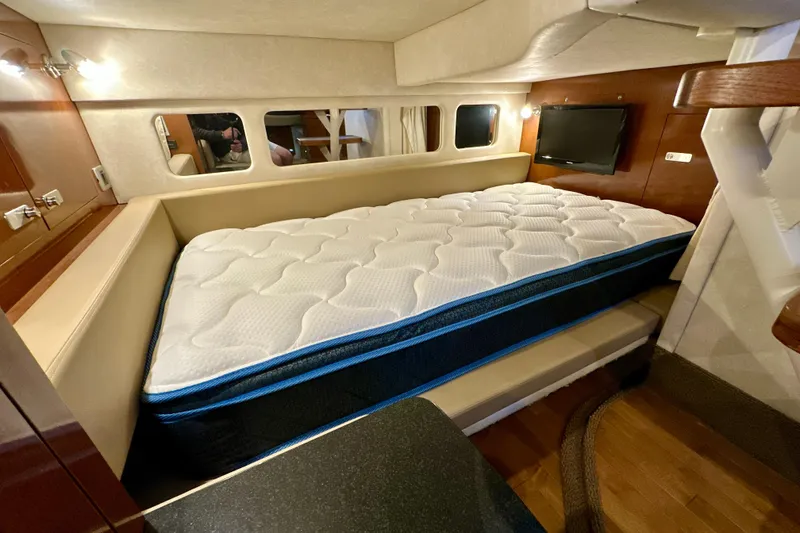Slide: The Image of Luxurious cabin interior of 2012 Sea Ray 330 Sundancer with comfortable mattress and modern amenities. - 13
