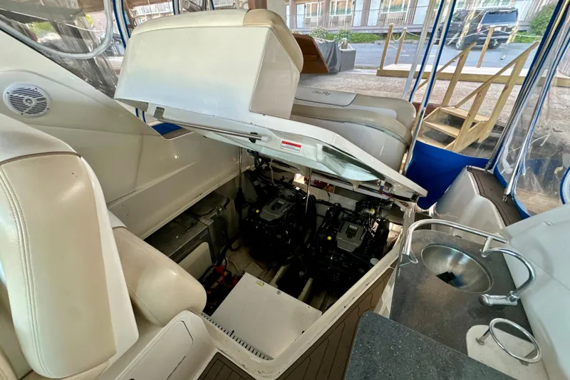 Slide: The Image of 2012 Sea Ray 330 Sundancer engine compartment with open hatch, showcasing interior details. - 15