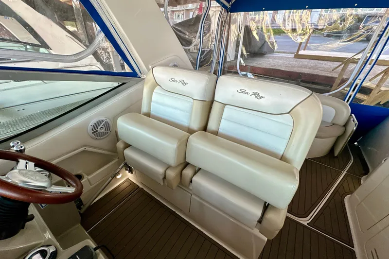 Slide: The Image of Interior of 2012 Sea Ray 330 Sundancer with beige seating and wooden accents. - 16