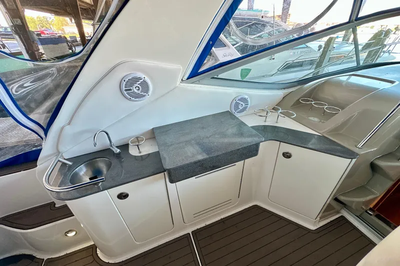 Slide: The Image of 2012 Sea Ray 330 Sundancer cockpit with sink, counter, and cup holders. - 3