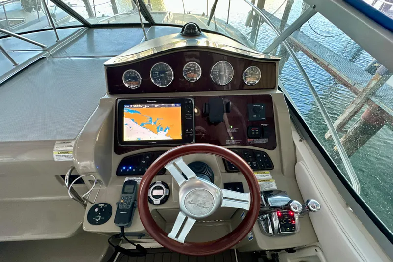 Slide: The Image of Cockpit of 2012 Sea Ray 330 Sundancer with navigation system and controls. - 6