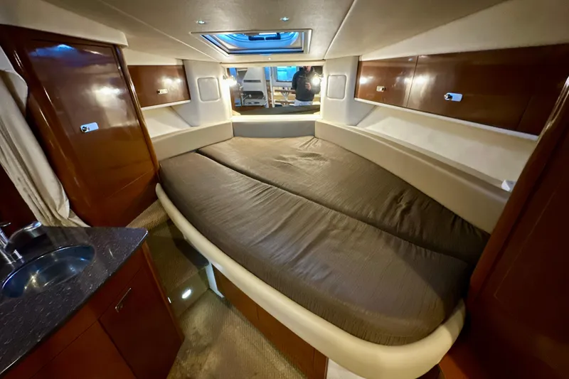 Slide: The Image of Interior cabin of 2012 Sea Ray 330 Sundancer with bed and wooden cabinetry. - 9