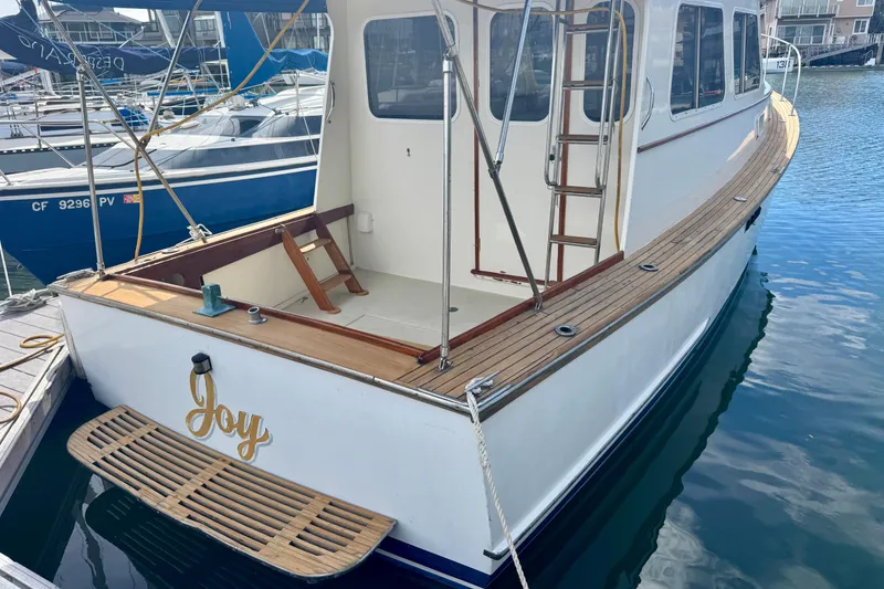 Slide: The Image of 1982 Jarvis Newman Flybridge Cruiser kitchen with double sink and wooden cabinetry. - 15