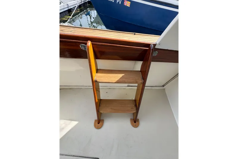 Slide: The Image of 1982 Jarvis Newman Flybridge Cruiser interior with seating, cushions, and storage shelves. - 20