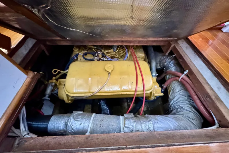 Slide: The Image of Wooden ladder on 1982 Jarvis Newman Flybridge Cruiser, docked near a blue boat. - 23