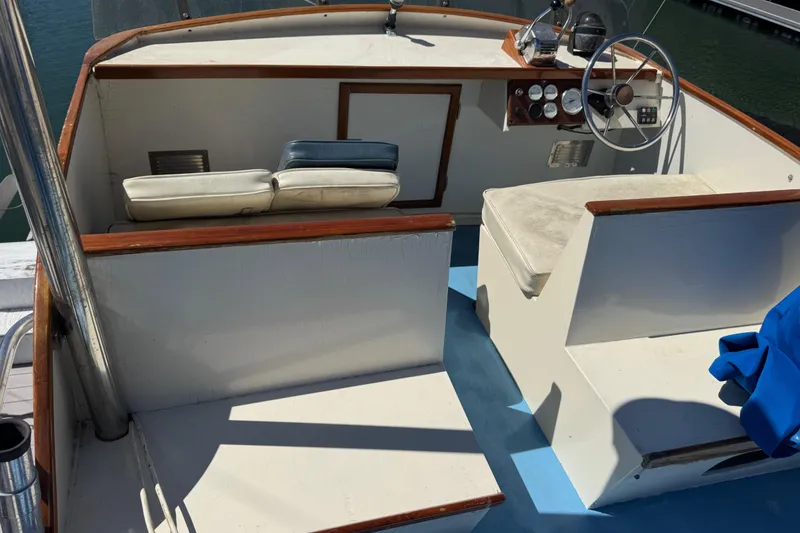 Slide: The Image of 1982 Jarvis Newman Flybridge Cruiser in marina, surrounded by sailboats and waterfront homes. - 36