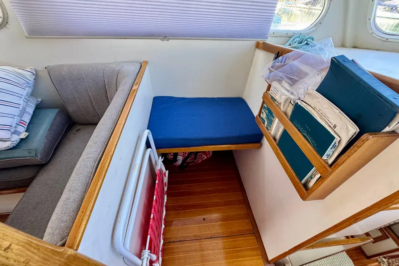 Slide: The Image of 1982 Jarvis Newman Flybridge Cruiser docked, featuring wooden deck and "Joy" nameplate. - 5