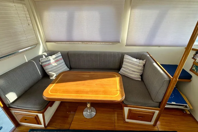 Slide: The Image of 1982 Jarvis Newman Flybridge Cruiser named "Joy" with wooden deck and swim platform. - 6