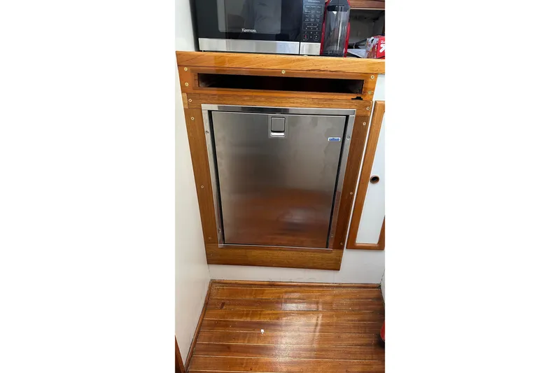 Slide: The Image of 1982 Jarvis Newman Flybridge Cruiser with wooden deck, docked in a marina. - 8