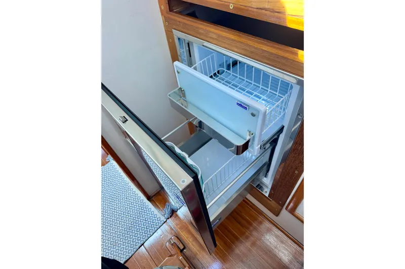 Slide: The Image of 1982 Jarvis Newman Flybridge Cruiser with ladder and cabin door at marina. - 9