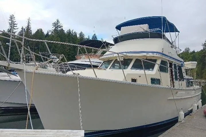 The Image of 1981 Tollycraft 43 Motor Yacht docked in serene forested marina. - 0
