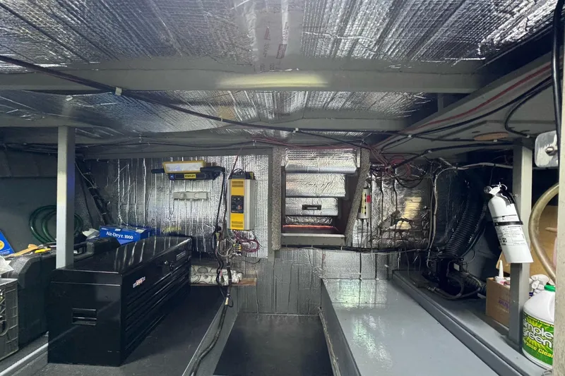 Slide: The Image of 1981 Tollycraft 43 Motor Yacht interior with dining area and helm station. - 15