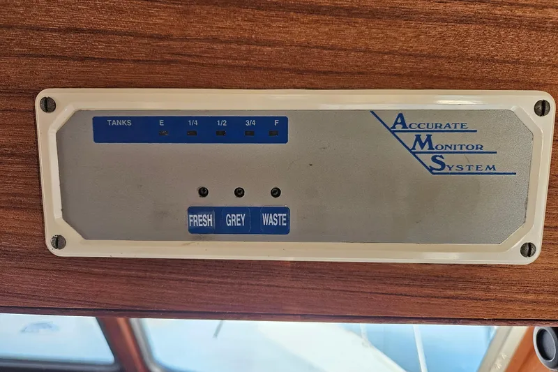 Slide: The Image of Accurate Monitor System panel on 1981 Tollycraft 43 Motor Yacht, displaying tank levels. - 24
