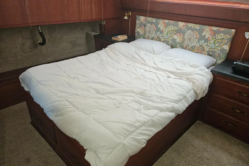 Slide: The Image of Cozy bedroom in 1981 Tollycraft 43 Motor Yacht with floral headboard and white bedding. - 28