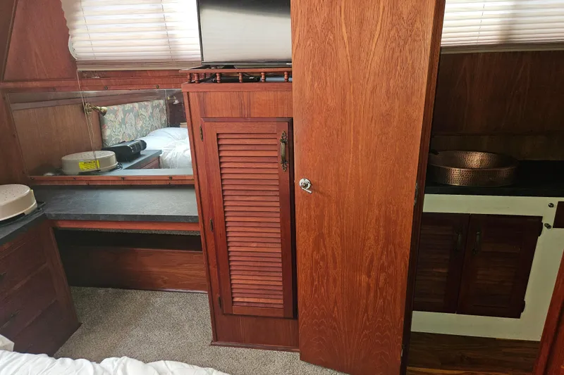 Slide: The Image of 1981 Tollycraft 43 Motor Yacht interior with wood cabinetry and cozy furnishings. - 31