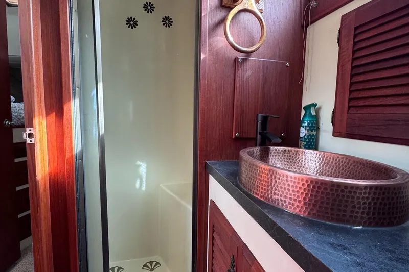 Slide: The Image of 1981 Tollycraft 43 Motor Yacht bathroom with copper sink and shower. - 33