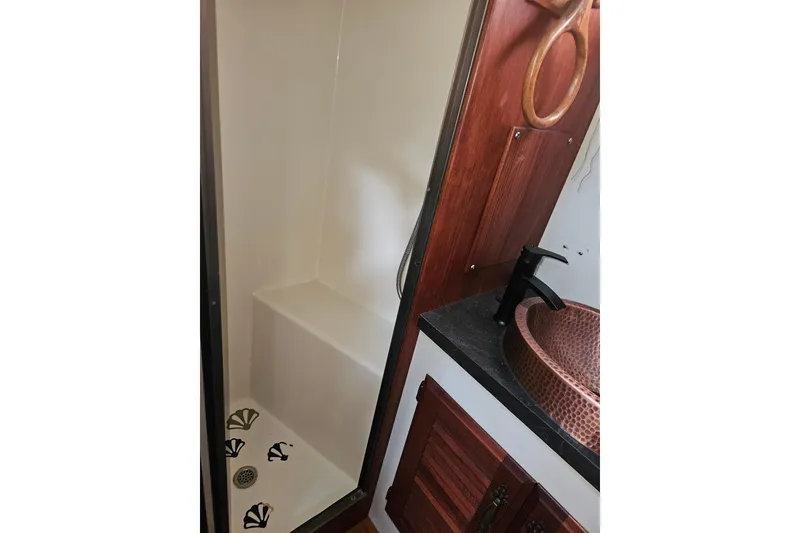 Slide: The Image of 1981 Tollycraft 43 Motor Yacht bathroom with shower and copper sink. - 34