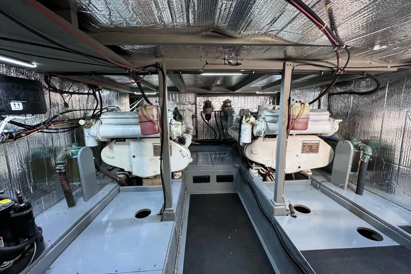 Slide: The Image of Engine room of a 1981 Tollycraft 43 Motor Yacht with dual engines and insulated walls. - 43