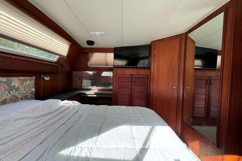 Slide: The Image of 1981 Tollycraft 43 Motor Yacht deck with railing and seating area. - 7