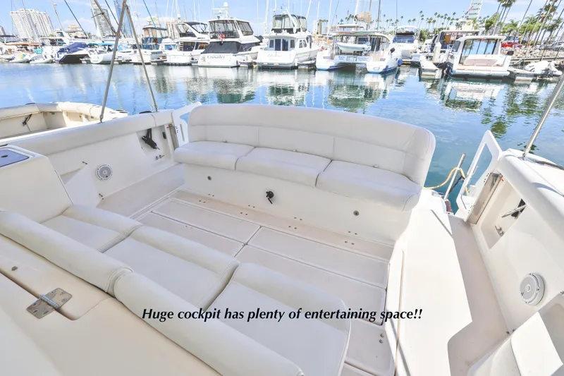Slide: The Image of 2003 Tiara 4000 EXPRESS yacht cockpit with spacious seating, docked in a marina. - 10