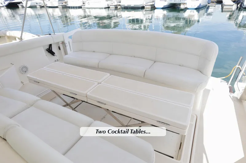 Slide: The Image of 2003 Tiara 4000 EXPRESS yacht with white seating and two cocktail tables. - 12