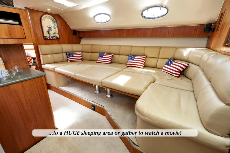 Slide: The Image of Luxurious interior of 2003 Tiara Yachts 4000 Express with plush seating and American flag pillows. - 21