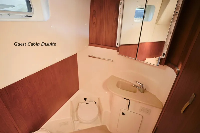 Slide: The Image of 2003 Tiara Yachts 4000 Express guest cabin ensuite with sink and mirror. - 28