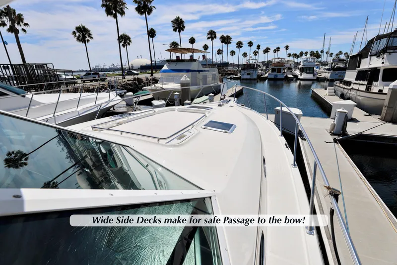 Slide: The Image of 2003 Tiara 4000 EXPRESS yacht with wide side decks in a marina setting. - 3