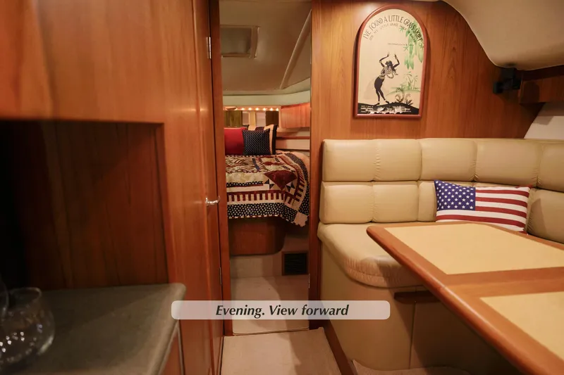 Slide: The Image of 2003 Tiara Yachts 4000 Express interior with cozy seating and American flag pillow. - 30