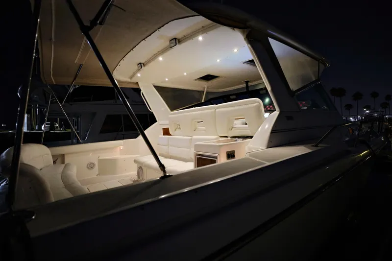 Slide: The Image of 2003 Tiara Yachts 4000 Express illuminated at night, showcasing luxurious seating and design. - 32