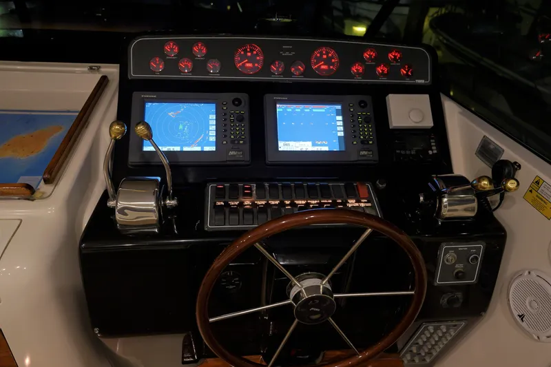 Slide: The Image of Dashboard of a 2003 Tiara Yachts 4000 Express with navigation screens and controls. - 33