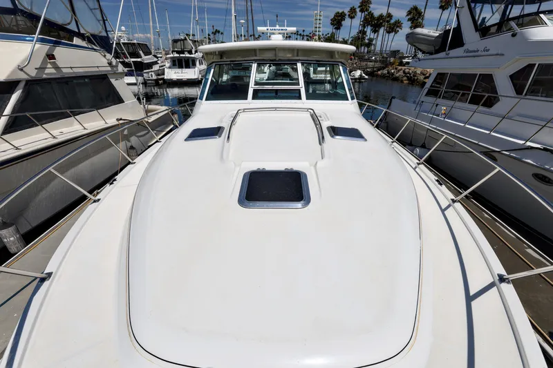 Slide: The Image of 2003 Tiara 4000 EXPRESS yacht docked at marina, surrounded by other boats. - 5